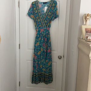 Beautiful turquoise wrap maxi dress. New with tags. Fits on target for an XL.